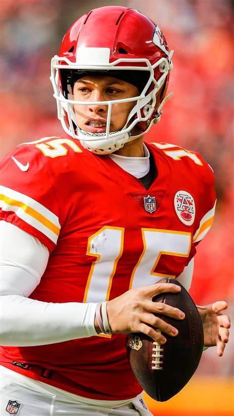 Patrick Mahomes in his Kansas City Chiefs uniform holding a football during a game.